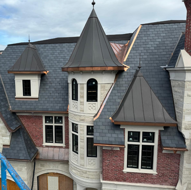 Slate roof with copper turrets and flashing